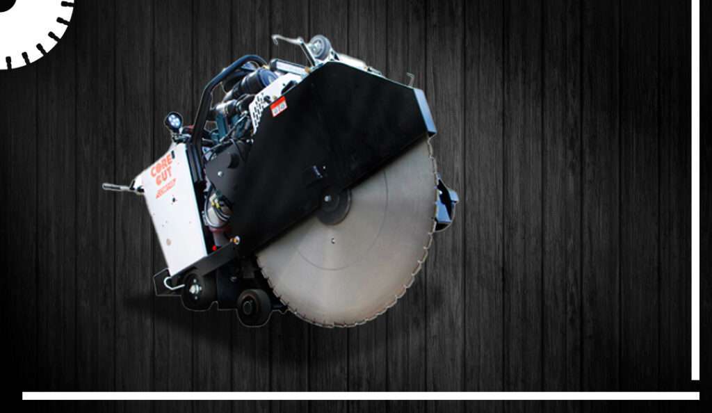 Large walk‑behind concrete floor saw with oversized diamond blade displayed against a dark wood background